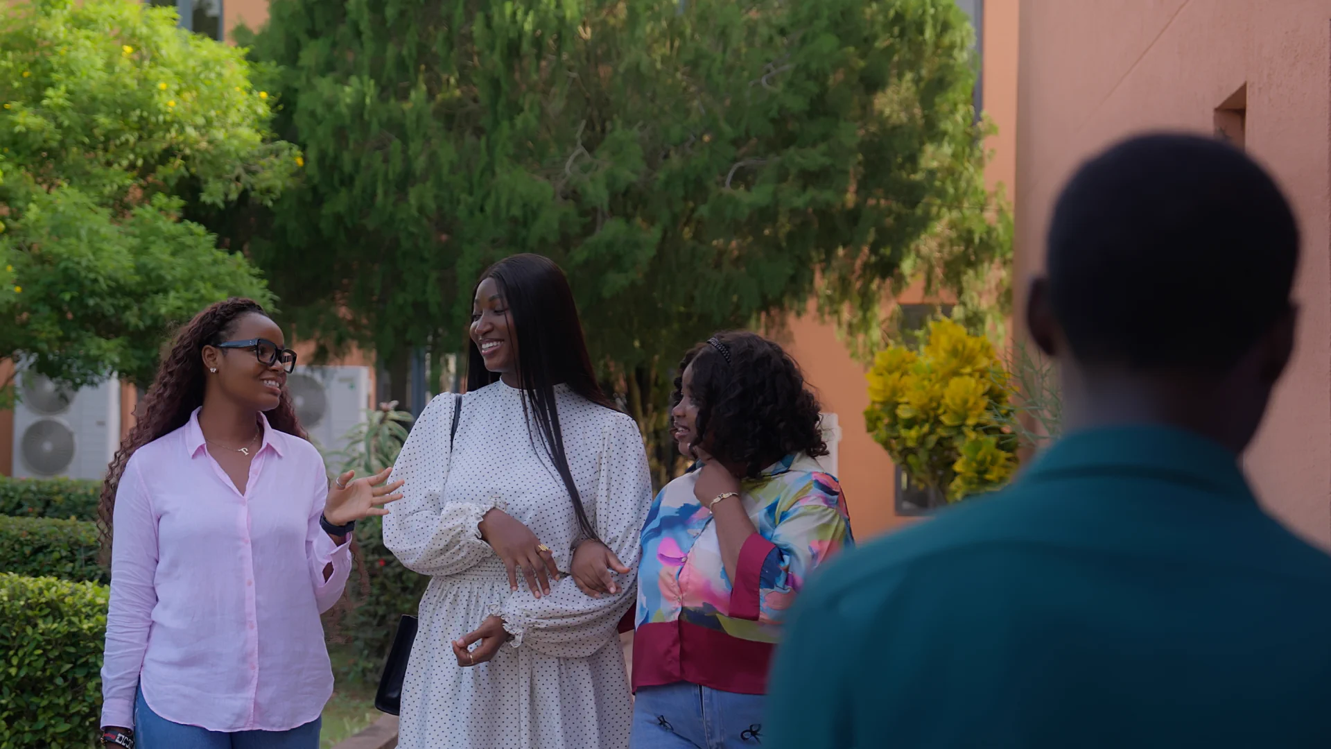 Wellspring University postgraduate students in conversation on campus